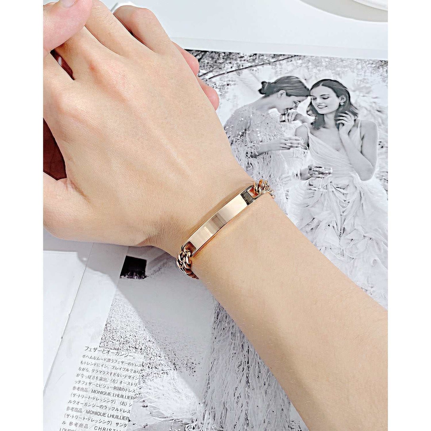Titanium steel curved plate rose gold bracelet on wrist.