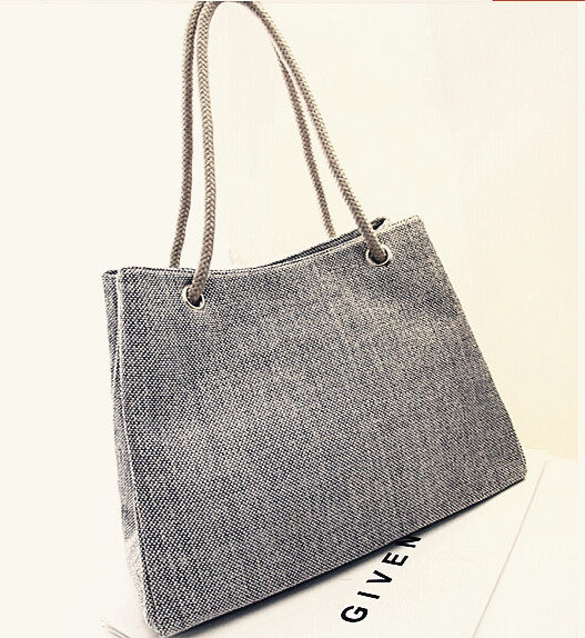 Large capacity women's canvas shoulder bag with soft handles.