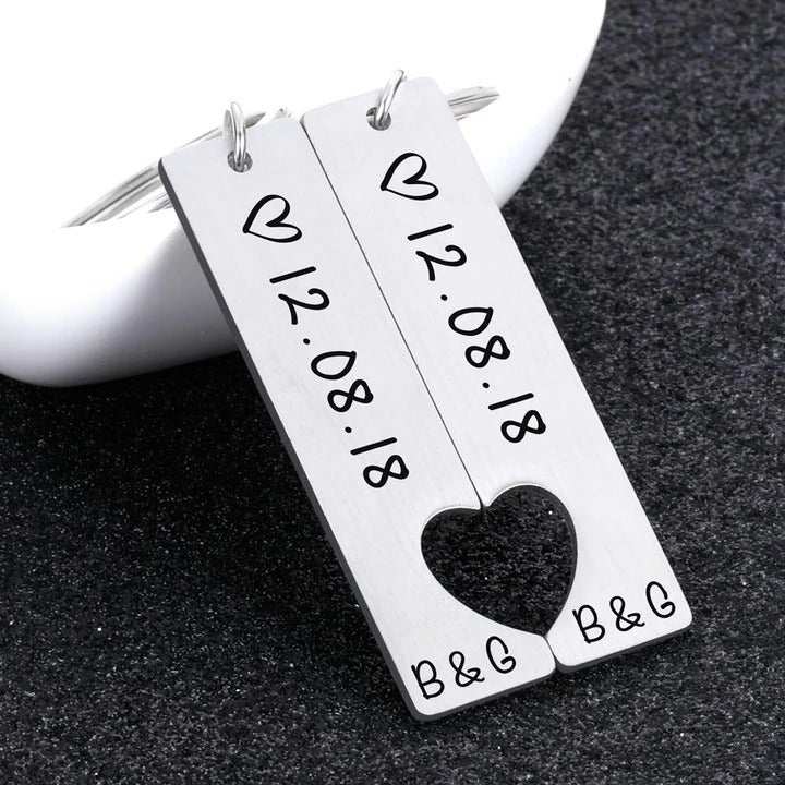 Customized couples keychain featuring engraved date with heart cutout, perfect for anniversary or Valentine's Day gift.