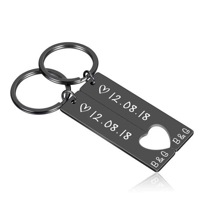 Customized couples keychain in black stainless steel with engraved date and initials, perfect anniversary gift.