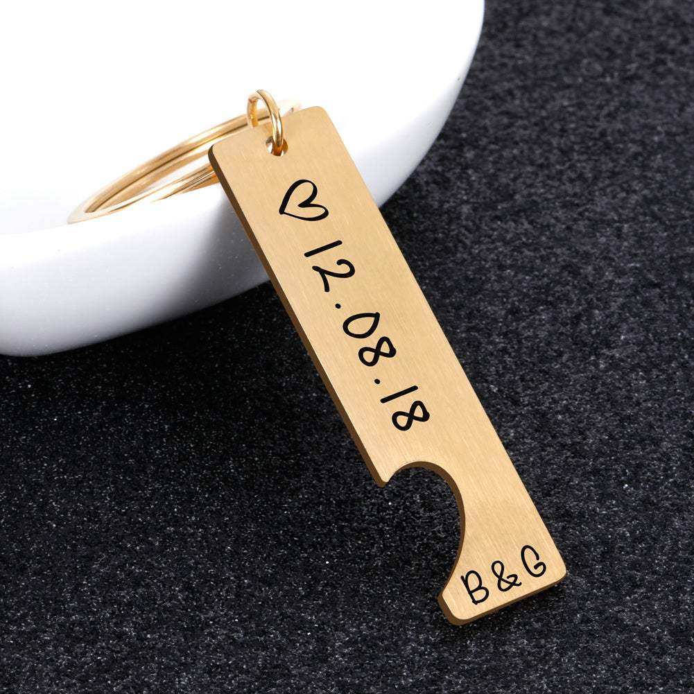 Customized couples keychain in gold with engraved date and initials, perfect anniversary gift.