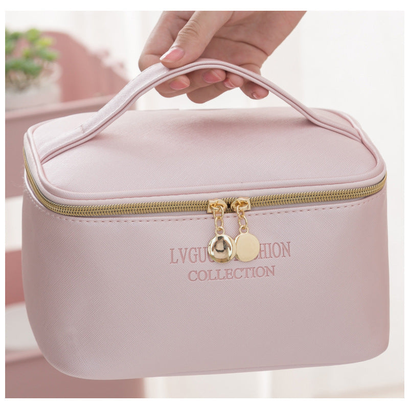 Medium pink waterproof storage bag with zipper, PU leather material, designed for travel and makeup organization.