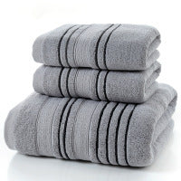 Gray pure cotton bath towels stacked, household essentials.