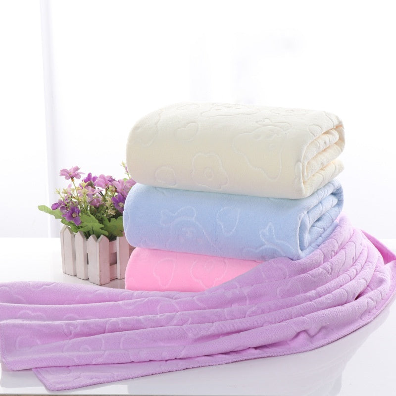 Microfiber thickened car wash cleaning towels in brown, dark blue, and dark purple on a table.