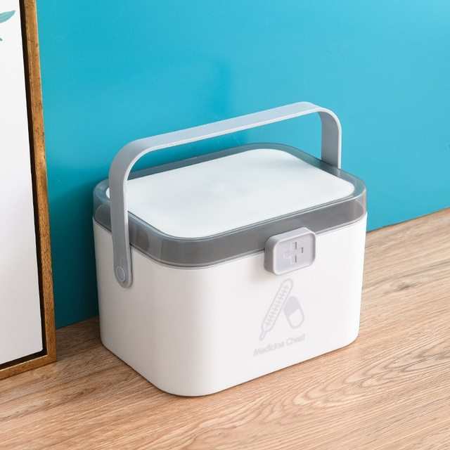 Portable double-layer first aid medicine box with handle in modern Nordic design.