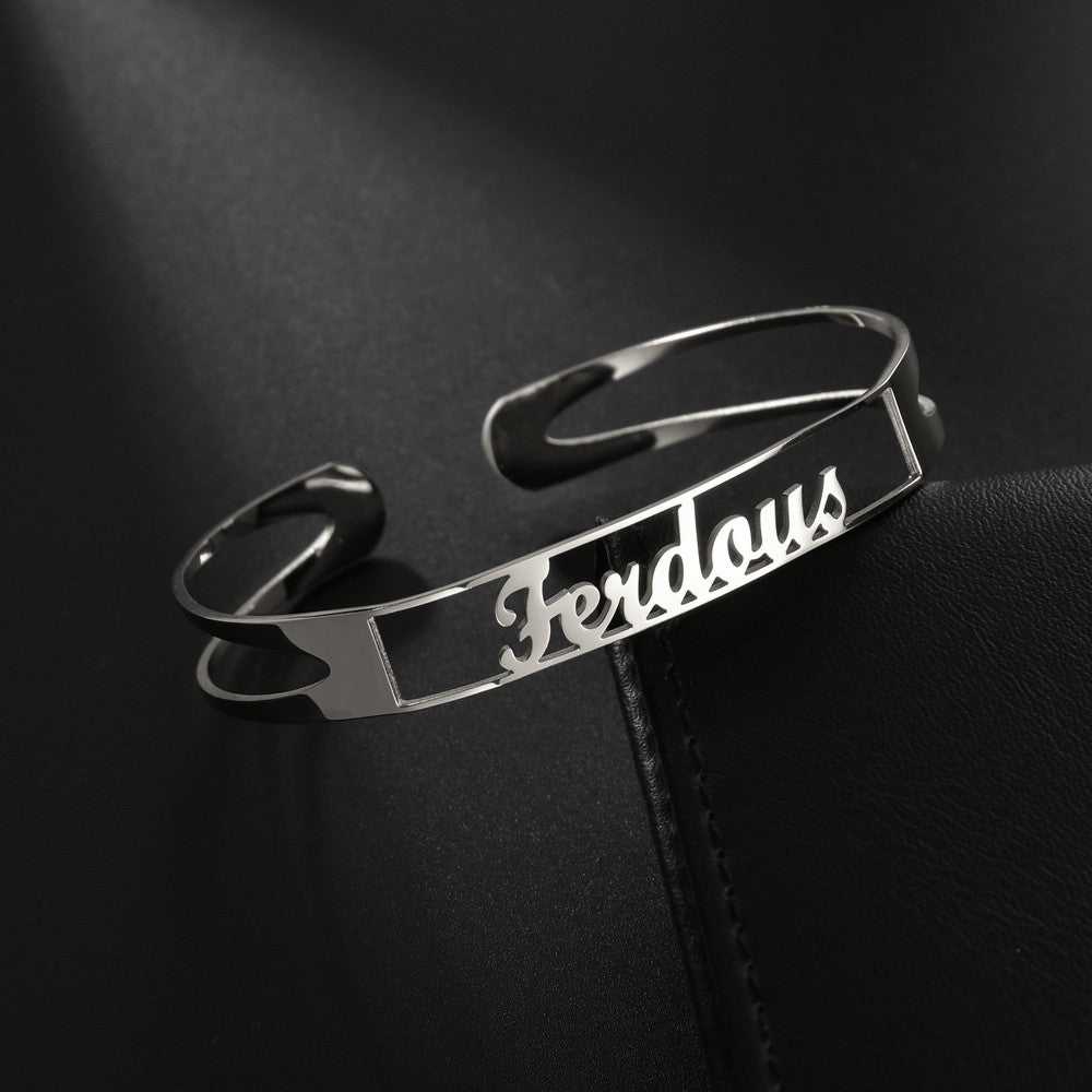 Customized name bracelet in stainless steel with personalized text, shown in silver.