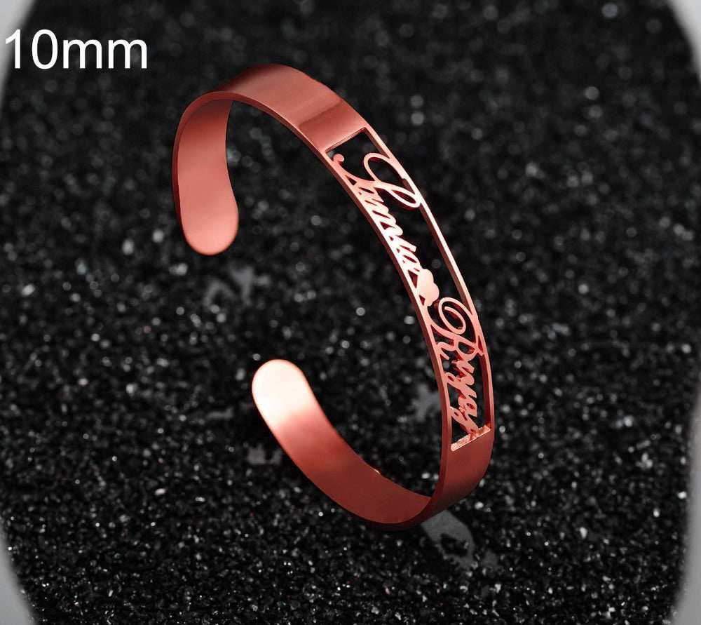 Customized name bracelet in rose gold stainless steel with intricate cut-out design.