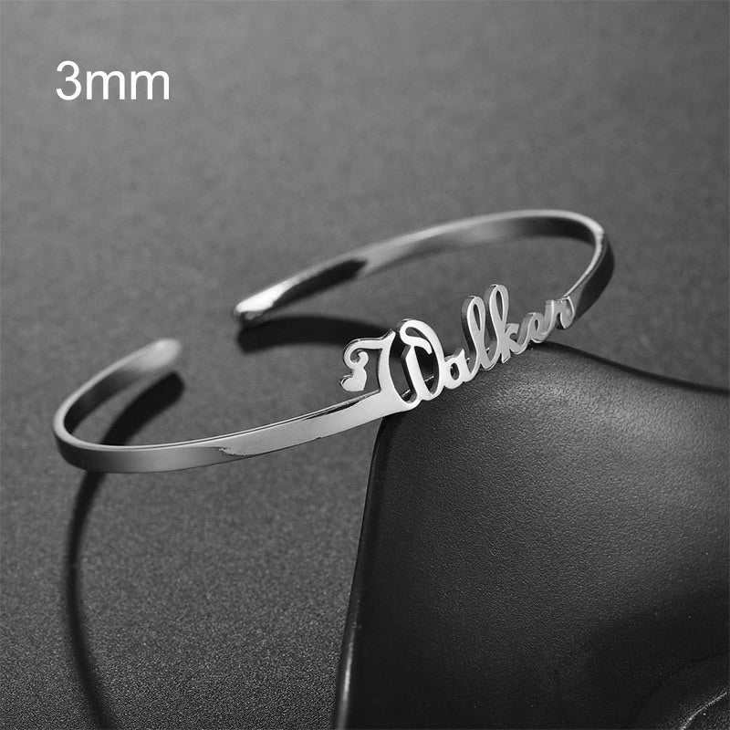 Customized name bracelet in silver stainless steel, featuring personalized detailing.