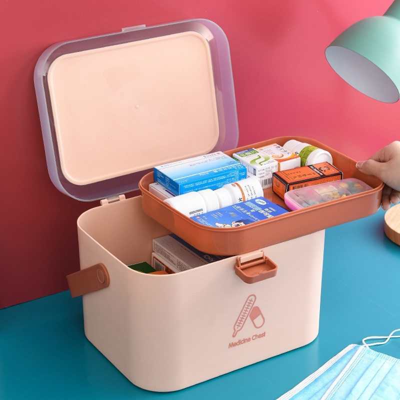 Portable double-layer medicine box in Nordic Pink, with compartments.