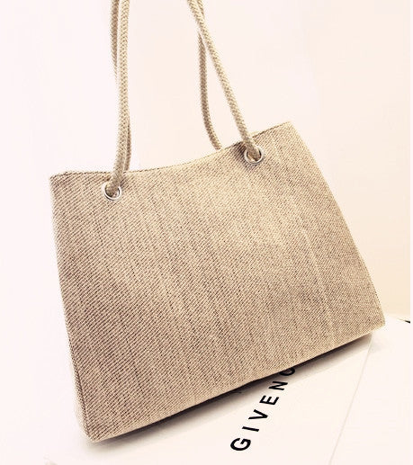 Large capacity Korean style woven shoulder bag in cotton and linen with soft handles.