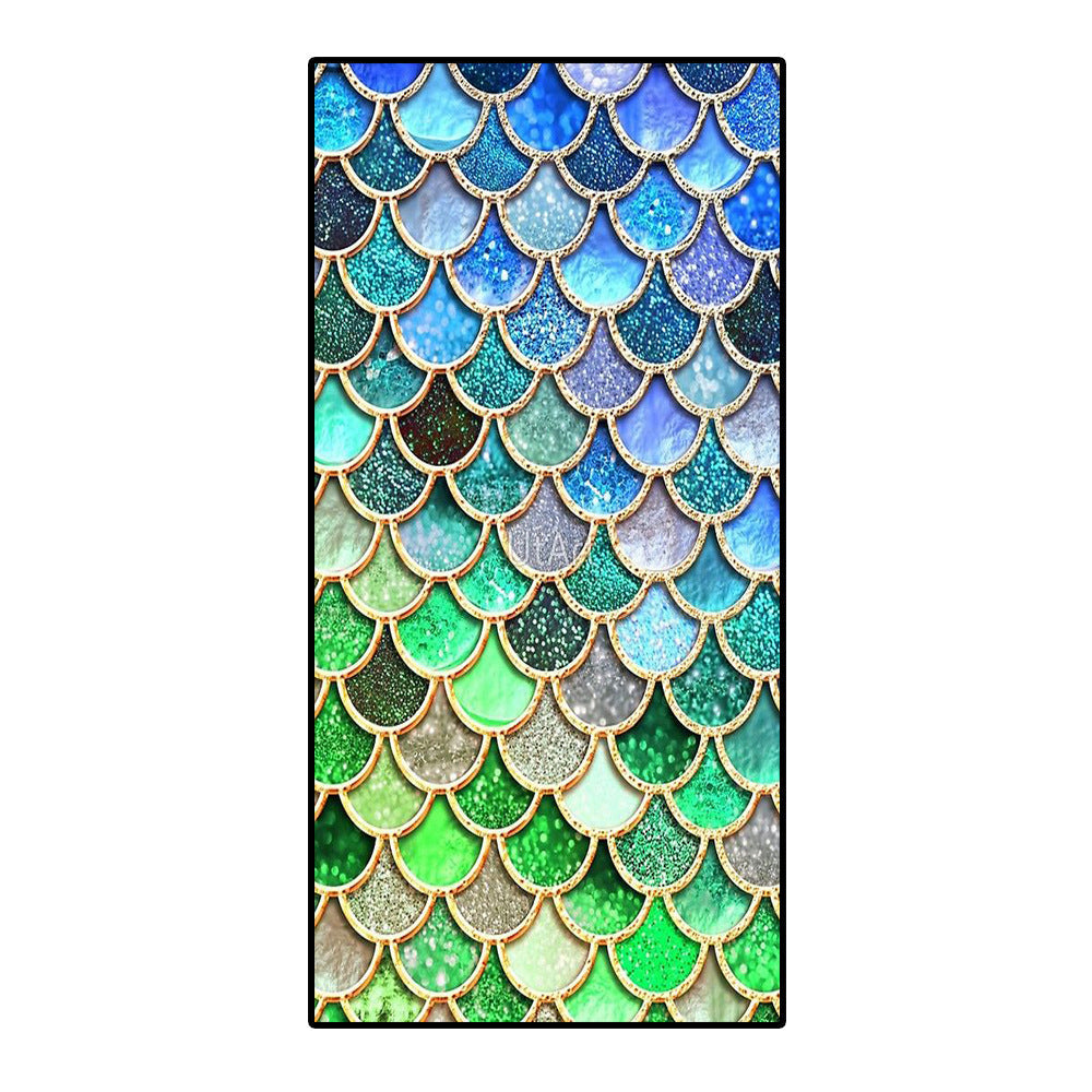 Microfiber bath towel with a colorful mermaid scale pattern.