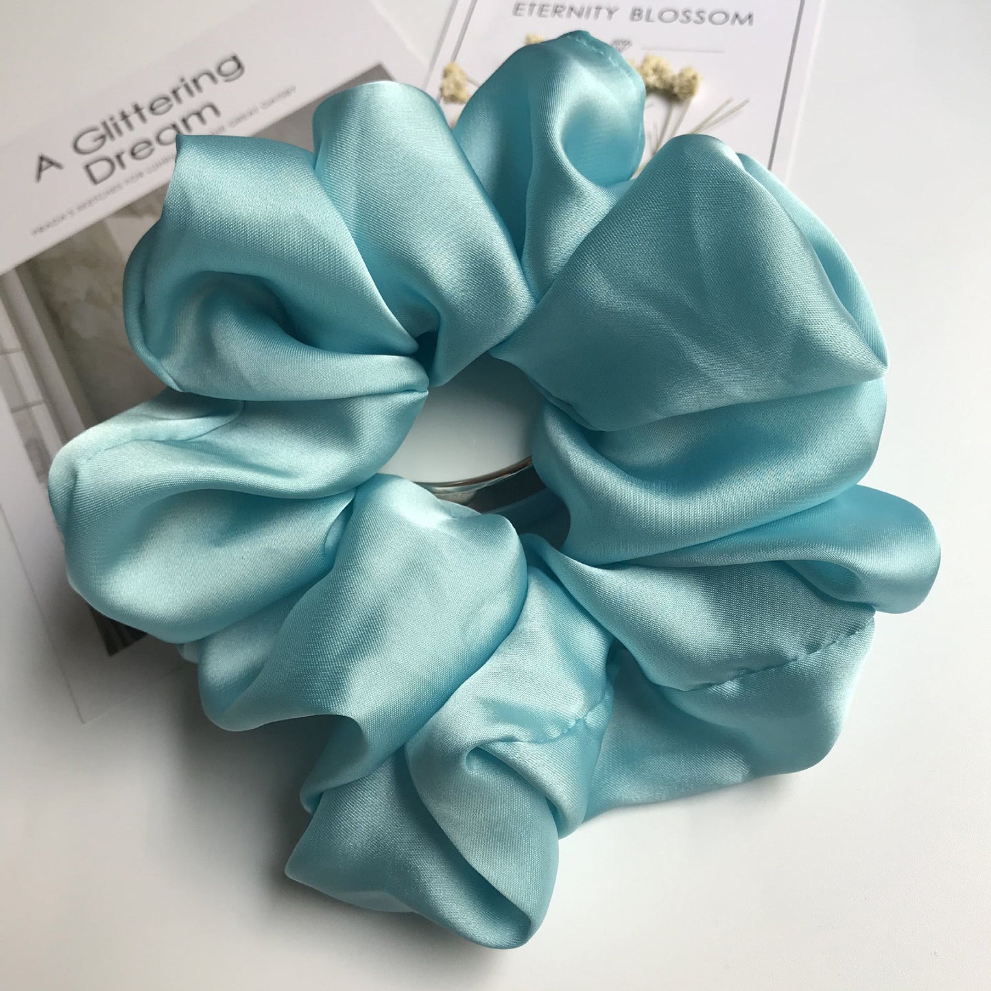 Oversized smooth satin large hair tie in light blue.