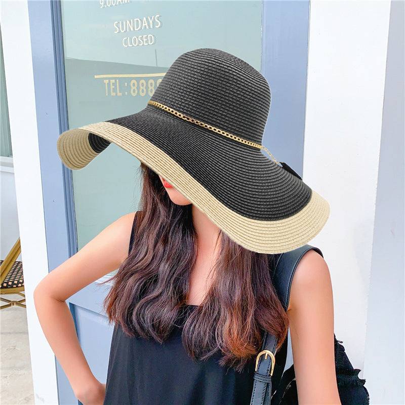 Women's summer sun protection beach hat with big brim in black and beige, flat top style.