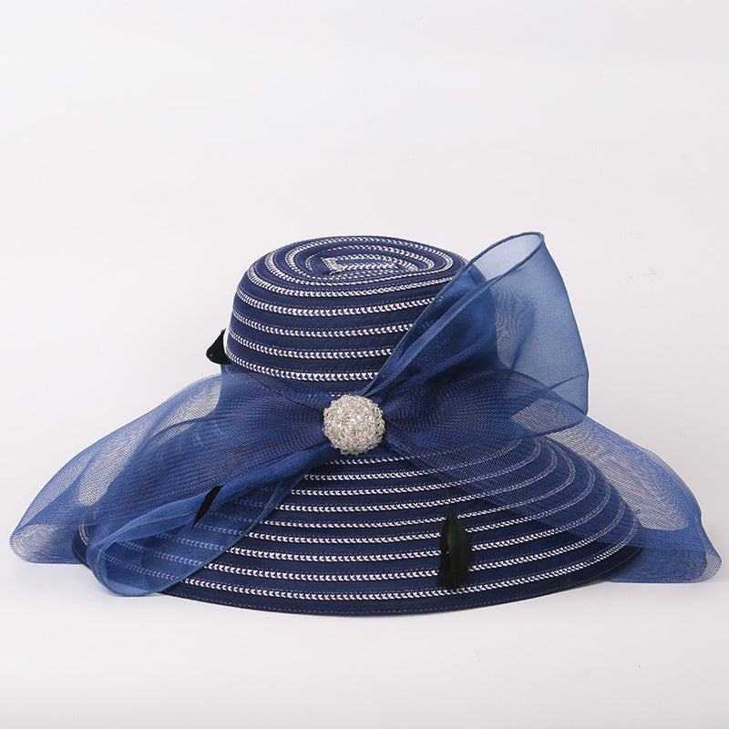 Big brim ladies sunshade hat with bow detail in blue, made from papyrus and polyester fiber.