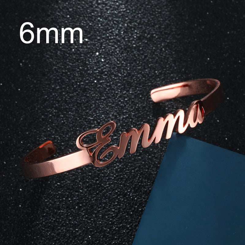 Customized name bracelet in rose gold with "Emma" engraving, personalized stainless steel jewelry.