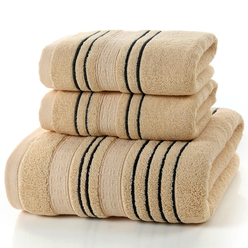 Household pure cotton bath towels in soft beige with black stripes stacked neatly.