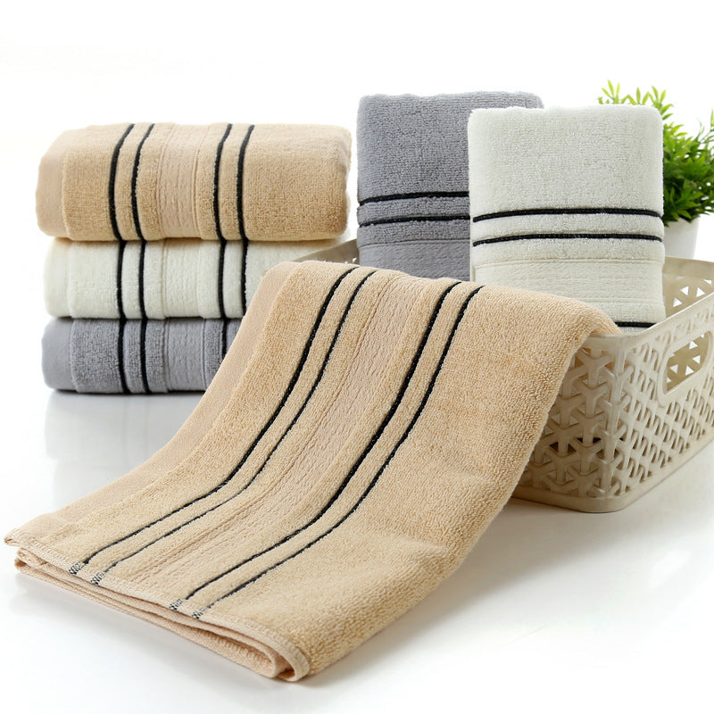 Household pure cotton bath towels in beige, gray, and white, displayed with stripes in a basket.