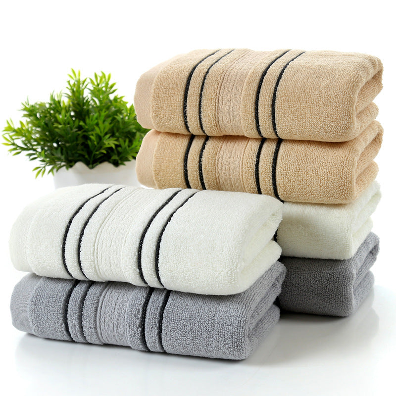 Soft, skin-friendly pure cotton bath towels in white, gray, and khaki.