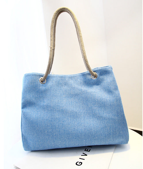 Large capacity blue linen shoulder bag with soft handle and woven design.