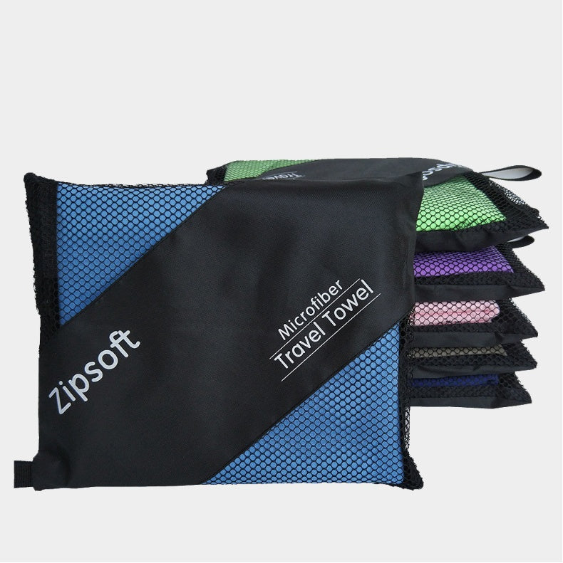 Microfiber exercise towels stacked in mesh carrying bags; various colors shown.