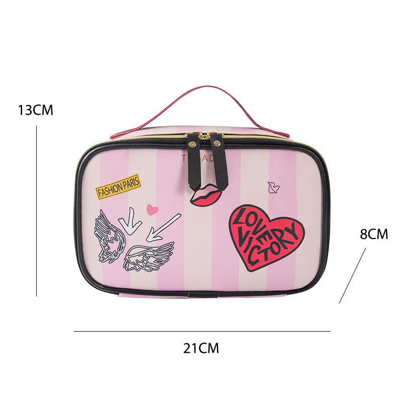 Small portable toiletry bag with pink stripes and printed designs, featuring a zipper closure and handle.