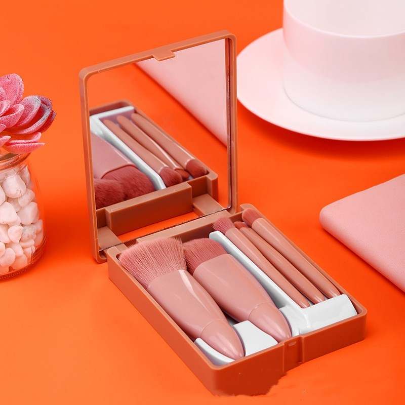 5-piece makeup brush set with mirror in pink case.