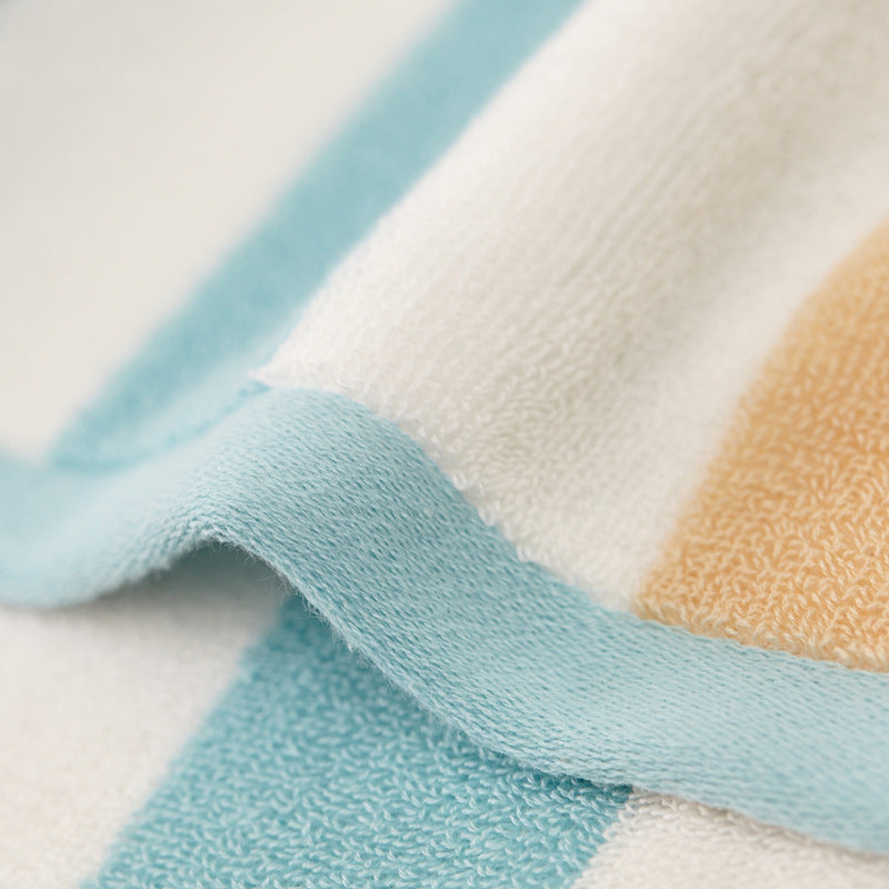 Close-up of cotton absorbent large bath towel with blue and peach stripes.