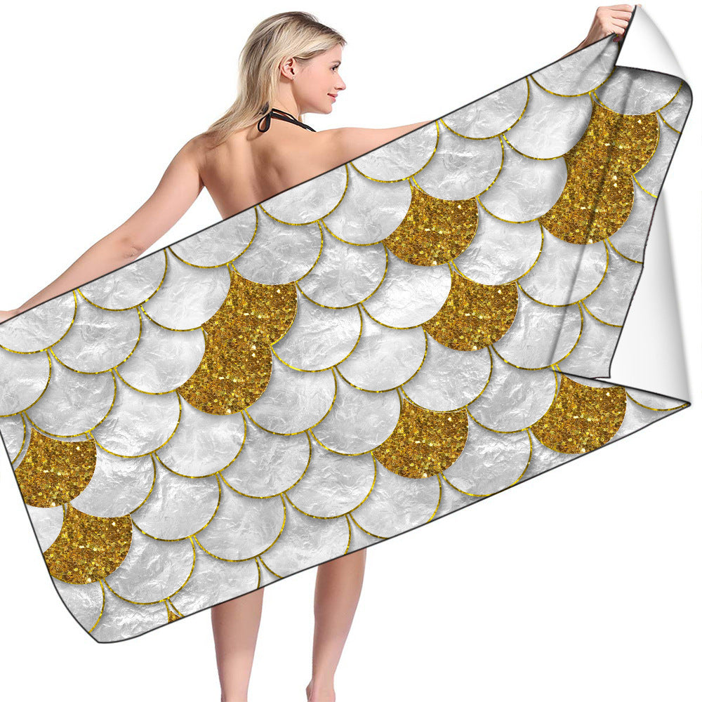 Microfiber bath towel with gold and white scale pattern, quick-drying, ideal for beach or holiday use.