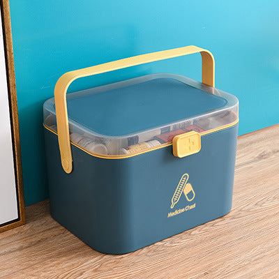 Portable double-layer first aid medicine box in Nordic Blue with yellow handle and cartoon design.