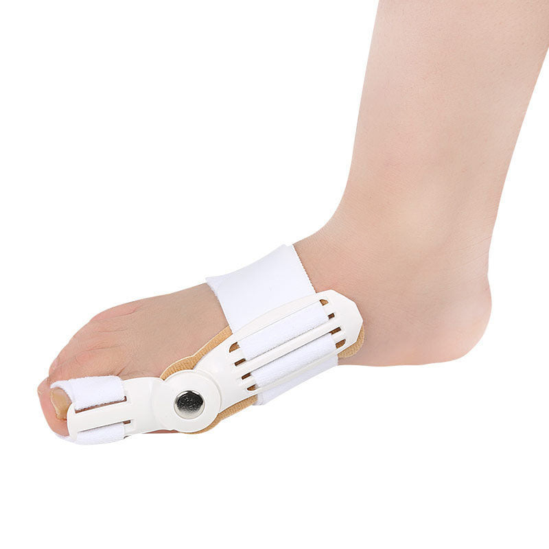 Hallux Valgus Corrector on foot, plastic toe sleeve for bunion relief and alignment.