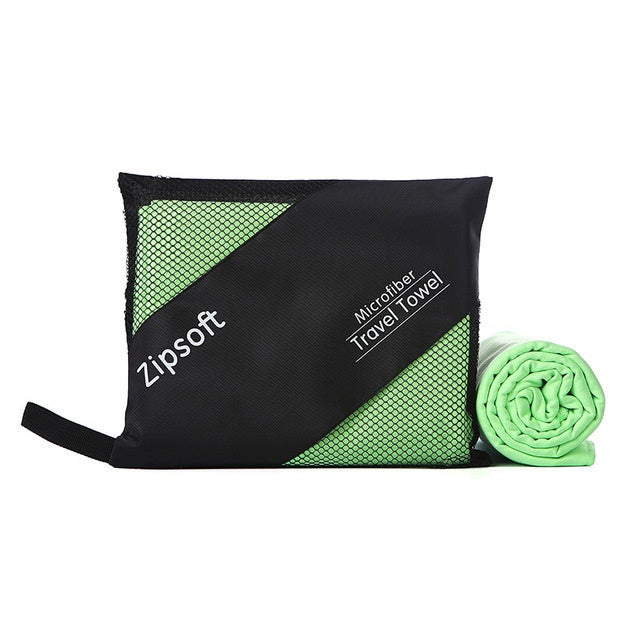 Green exercise towel made of superfine fiber and polyester, displayed with a black travel pouch.