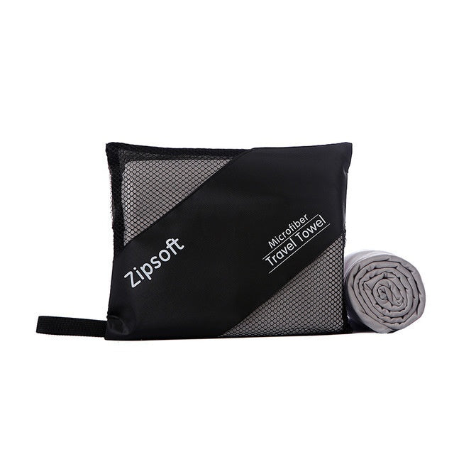 Exercise towel made of superfine polyester fiber, displayed with a compact carrying bag.