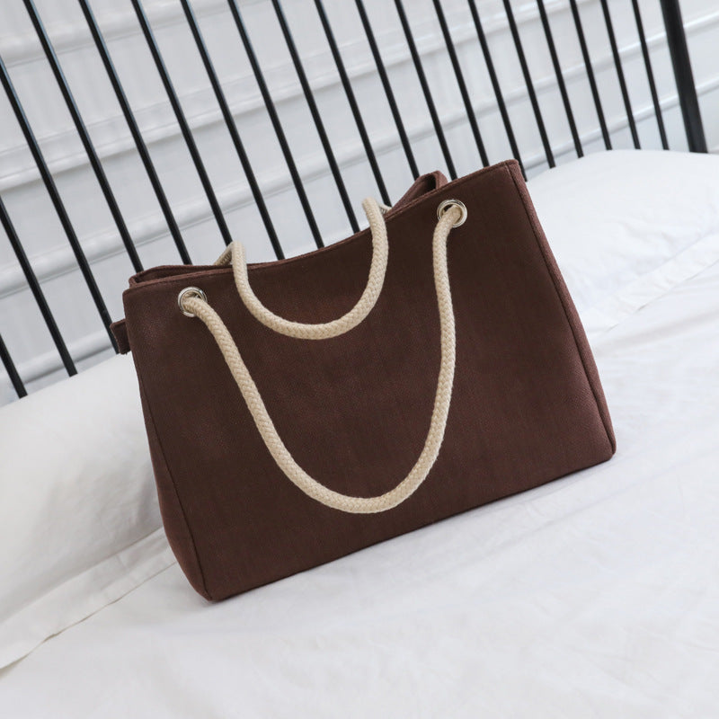 Large capacity brown linen shoulder bag with woven handles for women.