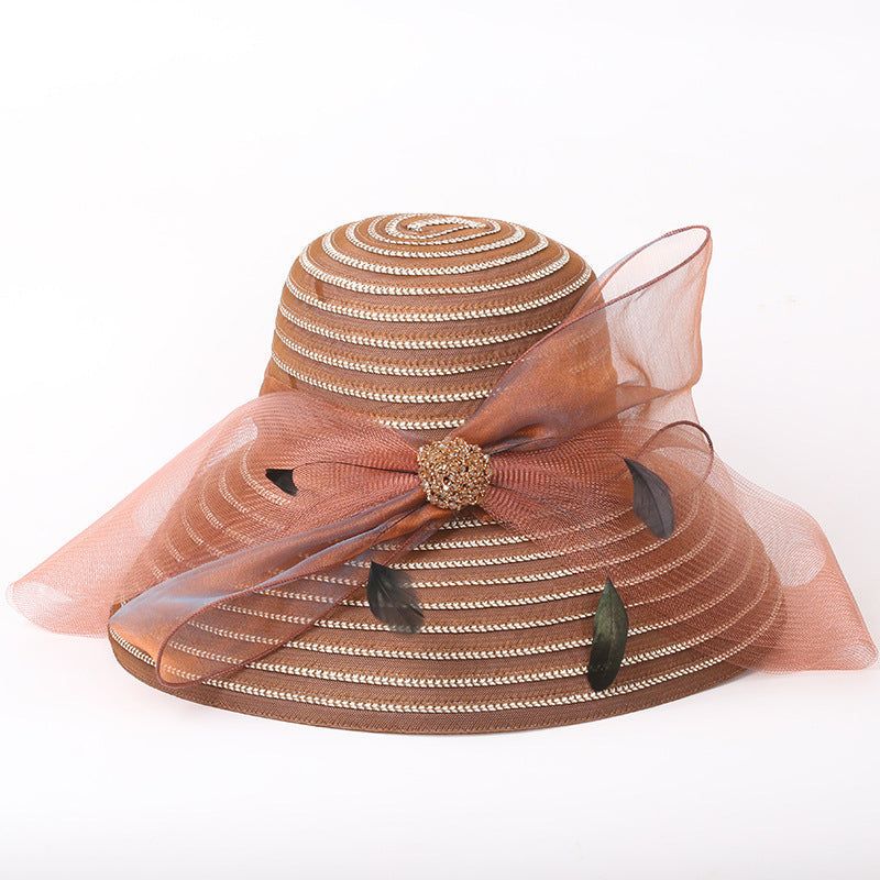Big brim ladies sunshade hat with bow, papyrus and polyester fiber material.