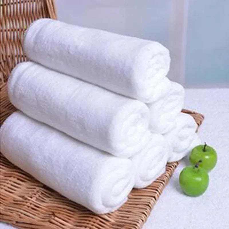 Absorbent thickened microfiber towels in a basket, white hotel room cleaning towels.