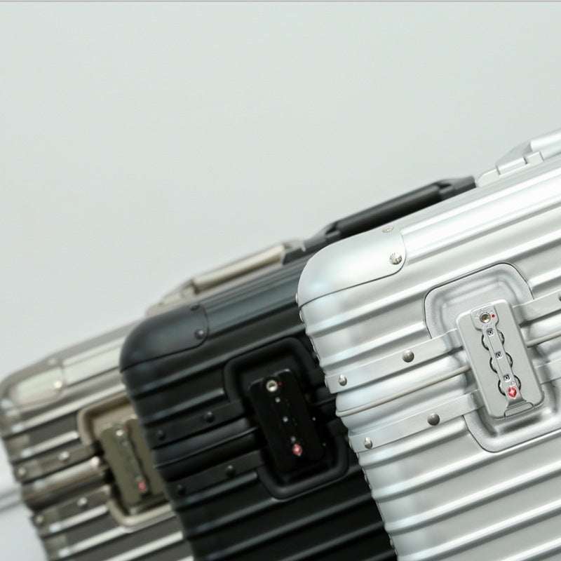 All-aluminum luggage trolley case in black, gold, and silver shades, featuring a robust metal design.