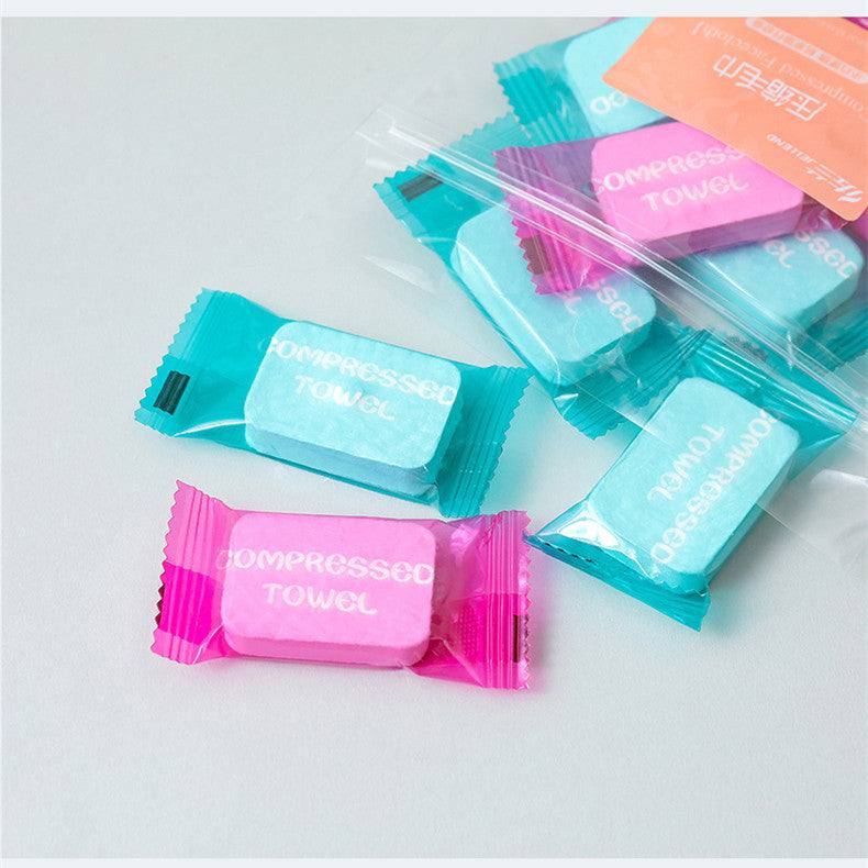 Candy-colored compressed towels in packaging, ideal for portable use.