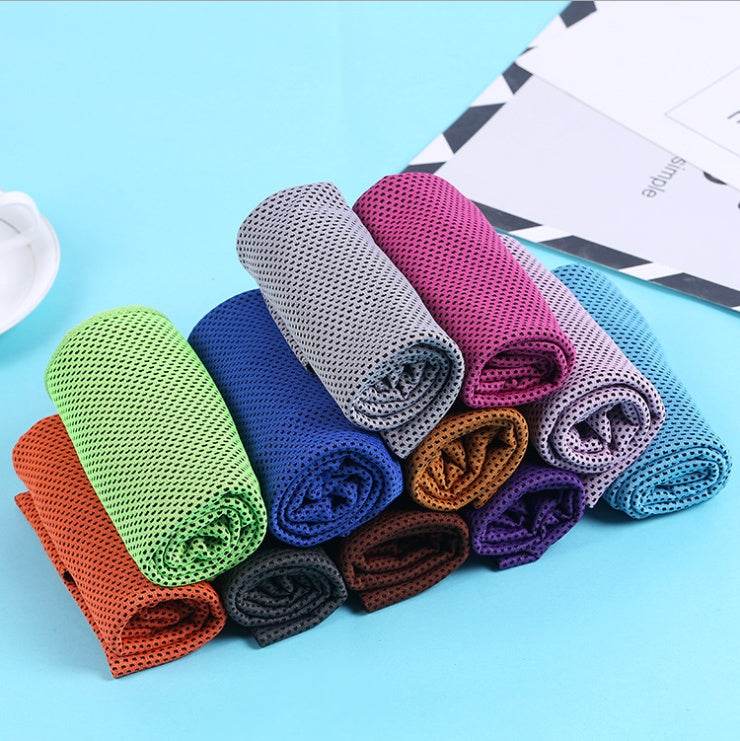 Colorful cooling towels made of polyester arranged neatly on a blue surface.