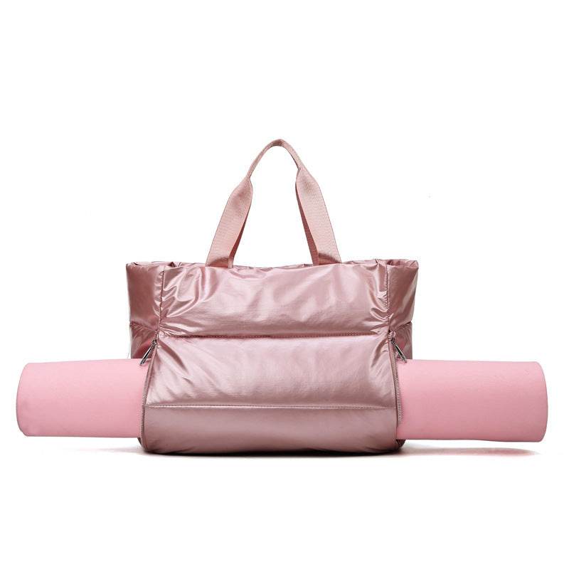 Women's pink gym bag with single soft handle made from durable nylon fabric.