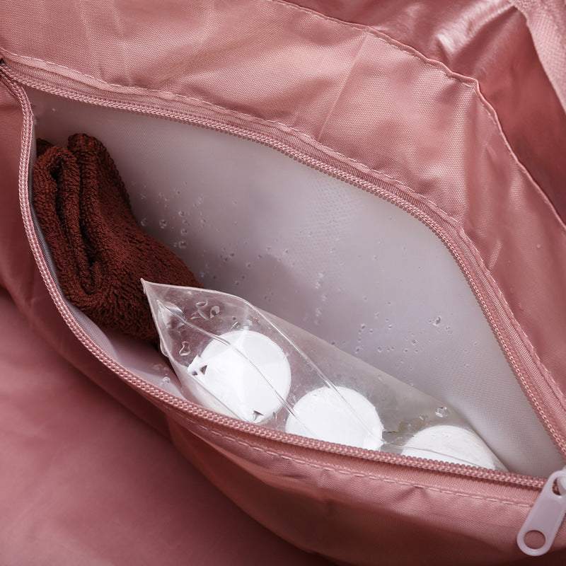 Interior view of a women's gym bag made from durable nylon with a zippered pocket holding toiletries.