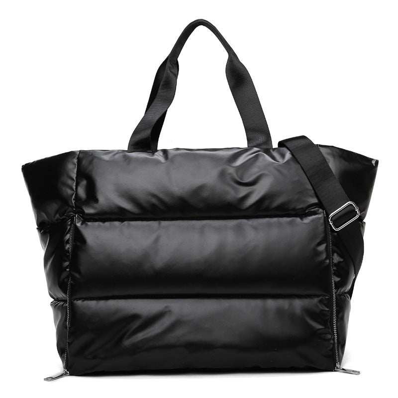Women's gym bag in durable nylon, featuring a soft handle and adjustable strap for versatile carrying options.