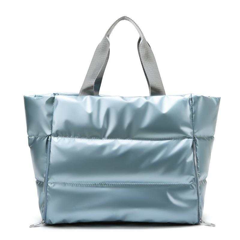 Durable women's gym bag with soft handles for versatile carrying.