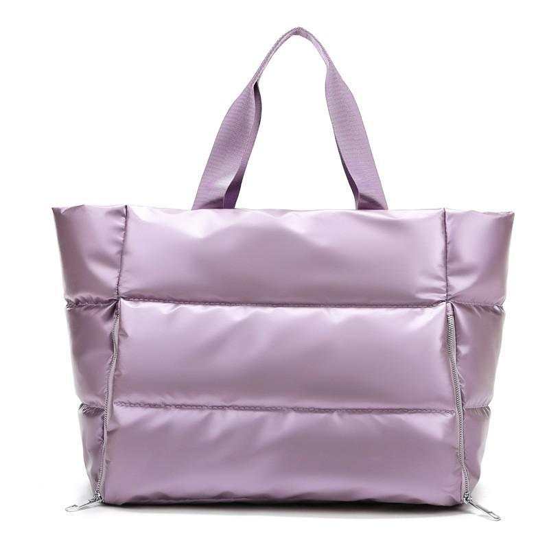 Durable women's gym bag in lavender nylon with soft handle for versatile carrying.