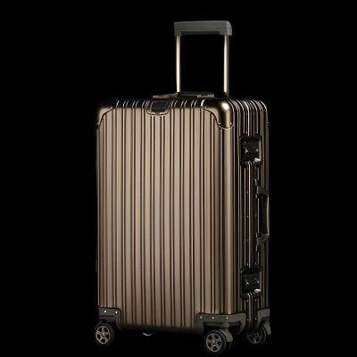 Sleek silver aluminum magnesium alloy luggage with universal wheels.