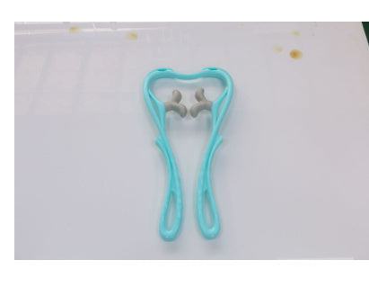 Six-wheel neck massager with ergonomic design, featuring two massage balls on a white surface.
