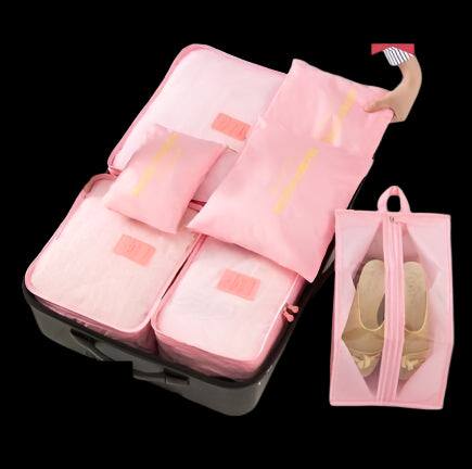 Packing bags set in pink, neatly arranged in a suitcase with additional shoe bag.