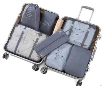 Open suitcase with organized travel luggage storage bags made of 210D Oxford cloth.