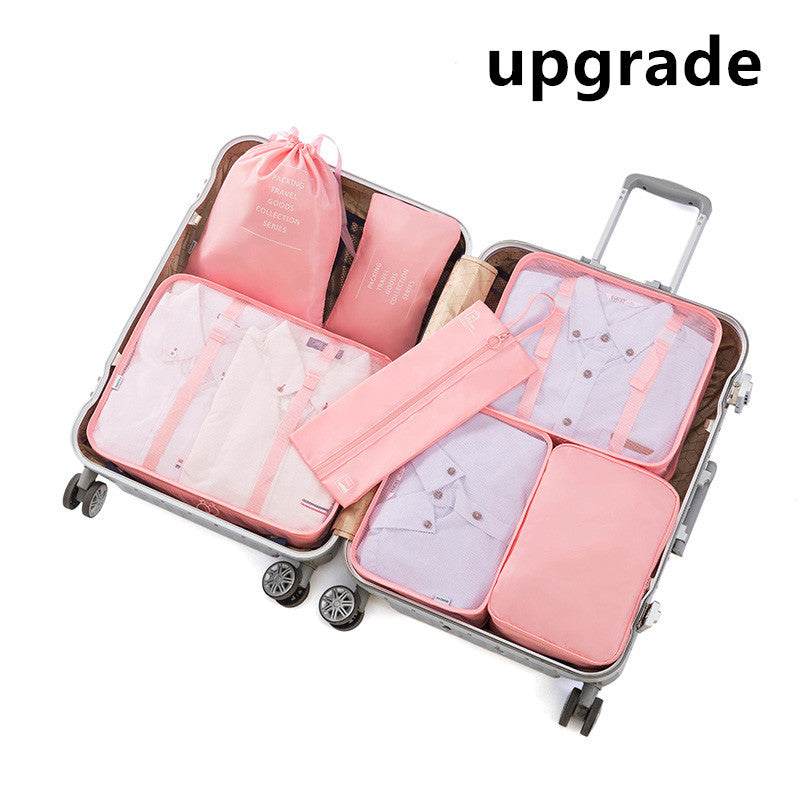 Travel luggage storage bag with pink packing cubes in an open suitcase.