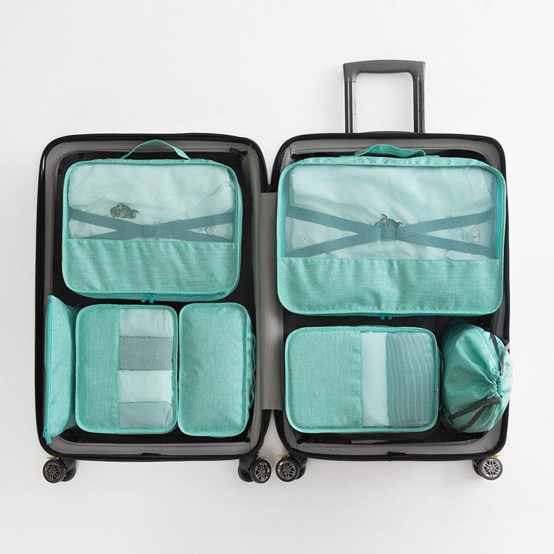 Waterproof travel tote bag set of 7 in teal displayed in an open suitcase, showing various sized bags for organization.