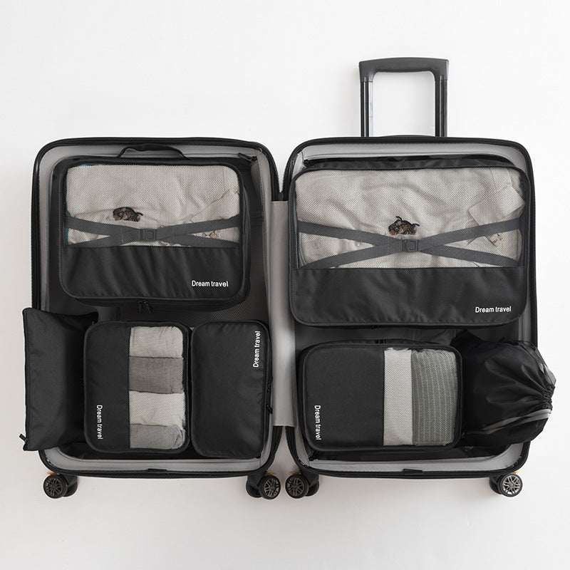 Waterproof travel tote bag set of 7 in black, organized inside a suitcase.